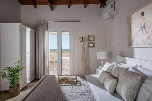 una camera con letto e vista sull'oceano di Kallisti Natural Villa a Kalamaki