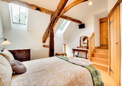 a bedroom with a king sized bed and a staircase at Crud y Werin in Llandderfel