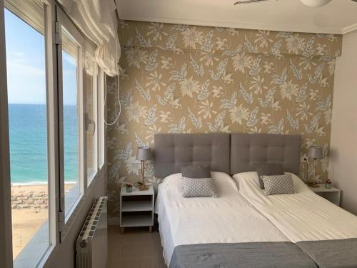 a bedroom with a bed and a view of the ocean at SeaMed in Málaga