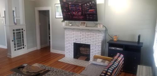 a living room with a white brick fireplace at 420 Friendly Charming 3 Bedroom, Walk To Downtown in Trinidad