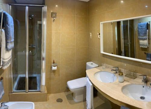 a bathroom with a sink and a shower and a toilet at SeaMed in Málaga