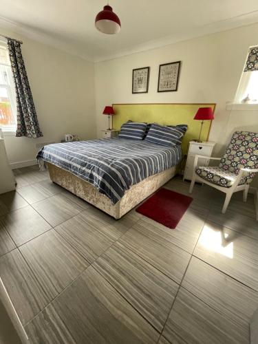 a bedroom with a bed and a chair at Saorsa House Culross in Fife