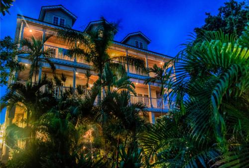 a building with palm trees in front of it at A Stone's Throw Away in Nassau