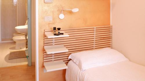 a bedroom with a bed and a sink and a toilet at Hotel Venezuela in Lido di Jesolo