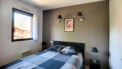 une chambre avec un lit et une fenêtre dans l'établissement A-Nature 01-Messsanges appartement 4 personnes dans résidence avec piscine, à Messanges