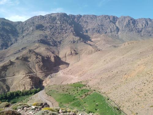 an aerial view of a mountain with a dirt road at Riad Dar Amgdoule Tacheddirt in Tacheddirt