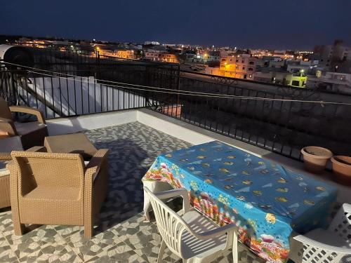 a bed on a balcony with a view of a city at Holiday triplex house in Gabès