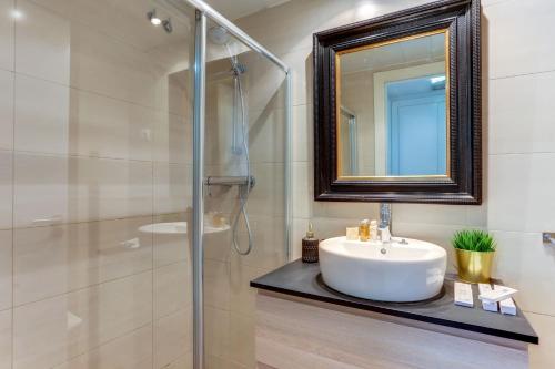 a bathroom with a sink and a shower and a mirror at Sweet Inn - Raul in Barcelona