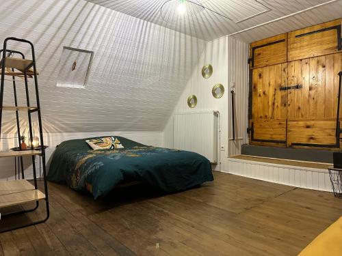 a bedroom with a bed and a ladder and a window at La Bergerie Marie in Saint-Aventin