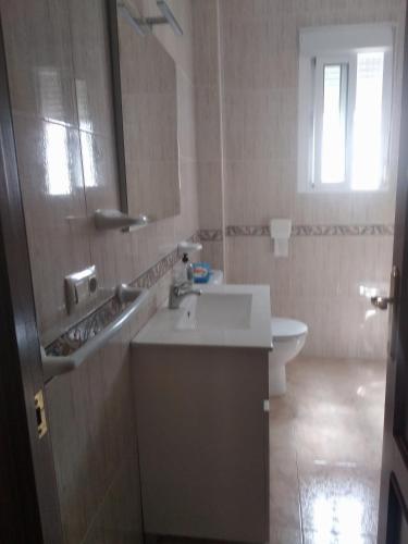 a bathroom with a sink and a toilet at El 20 in Barbate
