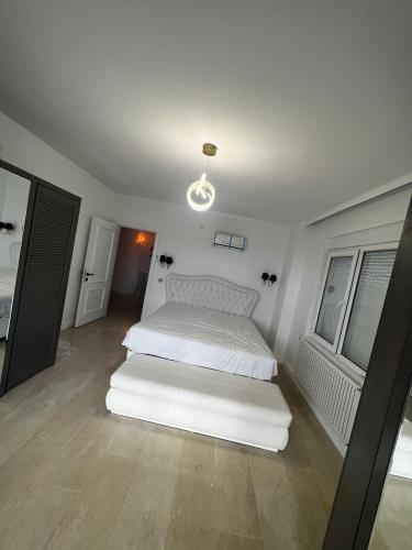 a bedroom with a white bed and two windows at Sharapsa village in Alanya