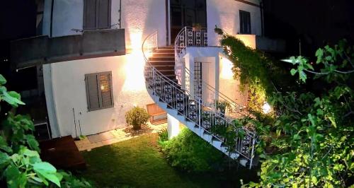 an external view of a house at night with stairs at Residenza Bertolini in Fosdinovo