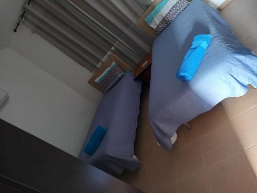 an overhead view of a bed with blue pillows at Sunset Villa in Nea Paphos