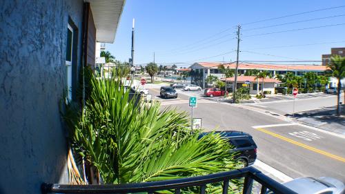 a balcony with a plant on the side of a building at Devon Shores in Clearwater Beach