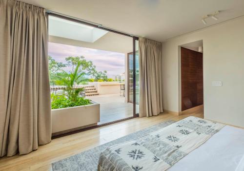 a bedroom with a bed and a large window at Casa Libre - Incredible huge condo with private pool and terrace in Aldea Zama by StayPodio 301 in Tulum