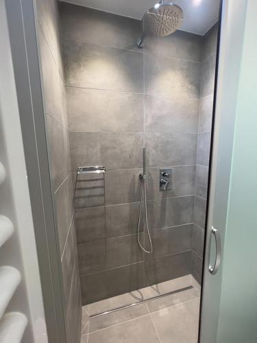 a shower with a glass door in a bathroom at Residenza Clelia Riccione in Riccione