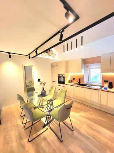 a kitchen and dining room with a glass table and chairs at Apartments Sea Pearl in Makarska