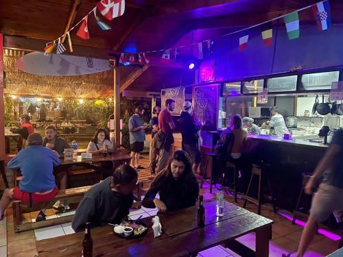 a group of people sitting at tables in a restaurant at Costa Rica Backpackers in San José