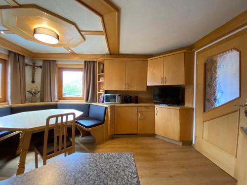 a kitchen with a table and a dining room at Budamerhof in Virgen