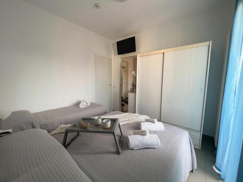 a living room with two beds and a table at Residenza Clelia Riccione in Riccione