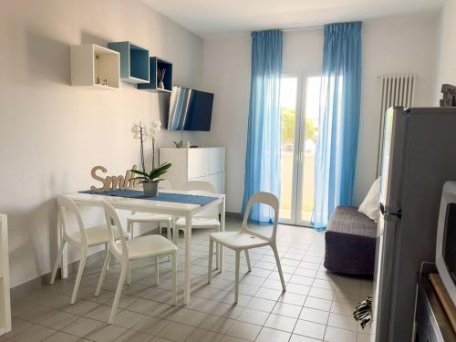 a kitchen and dining room with a table and chairs at Residenza Clelia Riccione in Riccione