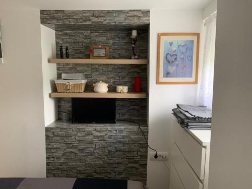 a brick fireplace in a living room with a brick wall at Nina in Arandjelovac
