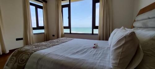 a bedroom with a bed with a view of the ocean at English Point Residence Beach Apartments Mombasa in Mombasa