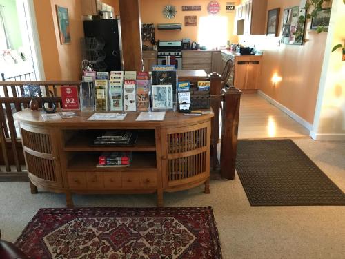 a kitchen with a table with books on it at Mancos Inn in Mancos