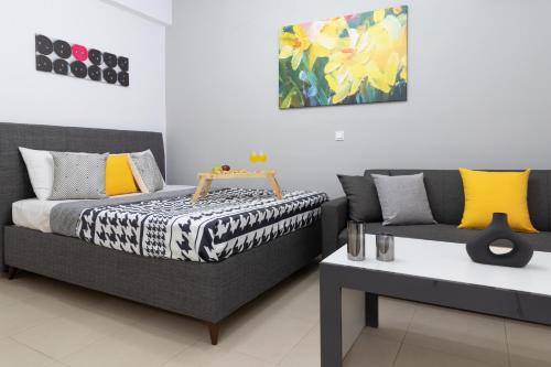 a bedroom with a bed and a couch and a table at K6 Fashion Sparta Apartment in Sparti
