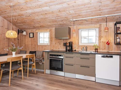 a kitchen with a table and a dining room at 4 person holiday home in Hemmet in Hemmet