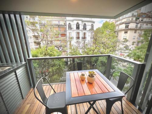 a balcony with a table and chairs on a deck at Exclusive Apartment in the Heart of Palermo Viejo PV1 by Apartments Bariloche in Buenos Aires