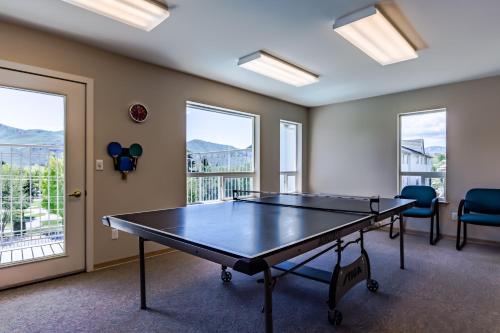 a ping pong table in a room with windows at Park Pointe Lago Vita C104 in Chelan