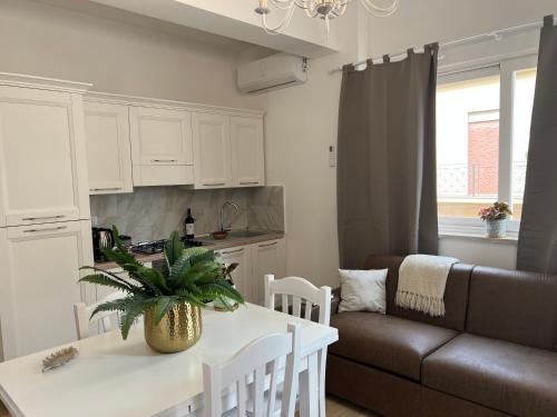 a kitchen and living room with a table and a couch at Caporama in Terrasini