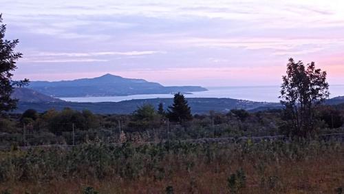 a view of a mountain and a body of water at Stone villa Halepa panoramic view, private pool,big garden & quiet in Néon Khoríon