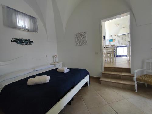 a bedroom with a bed with two towels on it at B&B Punta Cutieri in Gallipoli