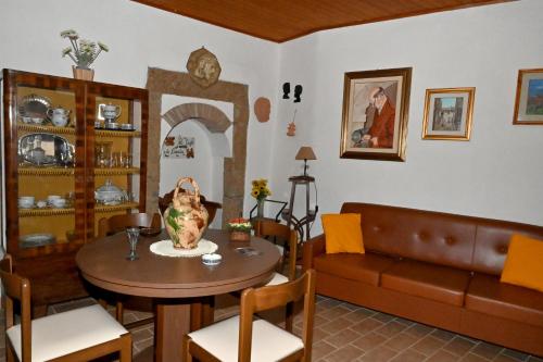 a living room with a table and a couch at IL TUFO E LA CASCATA in Pitigliano