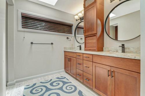 a bathroom with a large mirror and a sink at 7 Ginger Beer - Fairway Breeze in Hilton Head Island