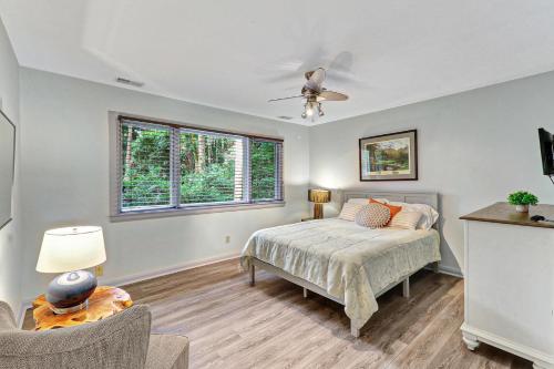 a bedroom with a bed and a ceiling fan at 7 Ginger Beer - Fairway Breeze in Hilton Head Island