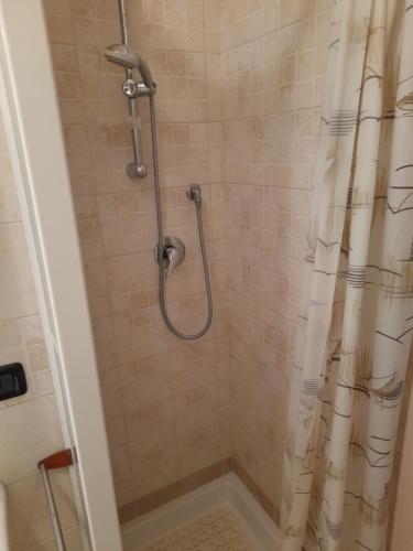 a bathroom with a shower with a shower curtain at Villa Marta la staccionata in Polignano a Mare