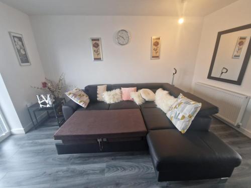 a living room with a couch and a coffee table at Enjoyable Home in Sunderland