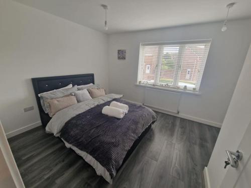 a bedroom with a large bed and a window at Enjoyable Home in Sunderland