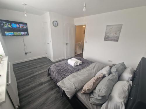 a bedroom with a bed with pillows on it at Enjoyable Home in Sunderland