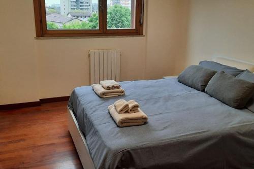 a bedroom with a large bed with towels on it at Casa della Commenda in Segrate