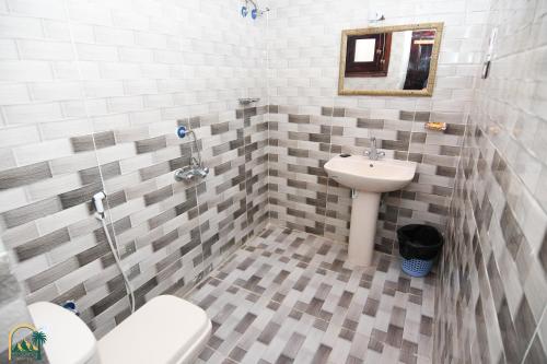 y baño con lavabo y aseo. en amzran hotel siwa en Siwa