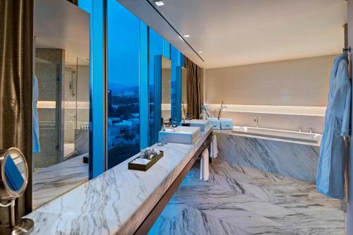 a bathroom with two sinks and a large mirror at The Westin Santa Fe, Mexico City in Mexico City