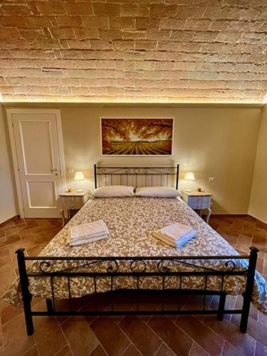 a bedroom with a bed with two books on it at Sangi Chianti Vacations in Poggibonsi