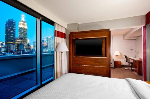a hotel room with a view of the city at Four Points by Sheraton Manhattan Chelsea in New York