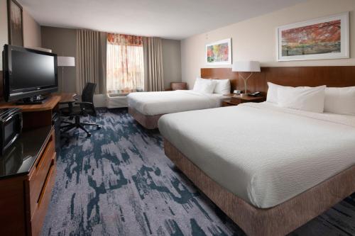 沃思堡Fairfield by Marriott Inn & Suites Fossil Creek的一间有两张床和一台平板电视的酒店房间