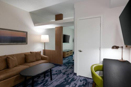 a living room with a couch and a table at Fairfield Inn & Suites by Marriott Atlanta Stonecrest in Lithonia