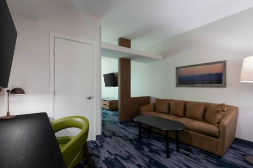 a living room with a couch and a table at Fairfield Inn & Suites by Marriott Atlanta Stonecrest in Lithonia